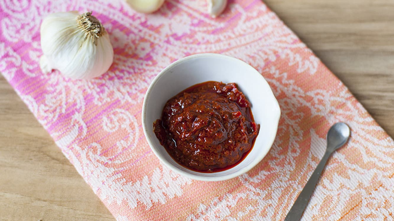 algerian chile paste served next to a piece of garlic